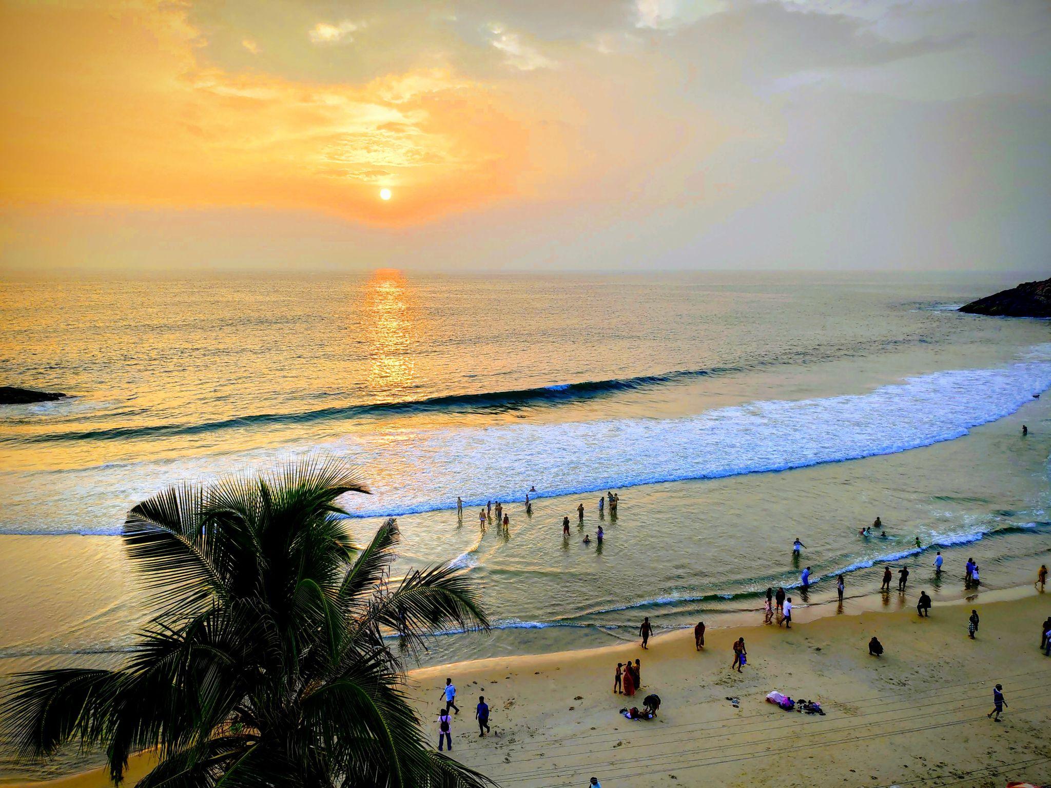 Golden sunset casting warm light over the Arabian Sea at Kovalam Beach